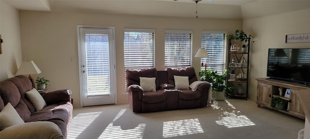 carpeted living room featuring ceiling fan