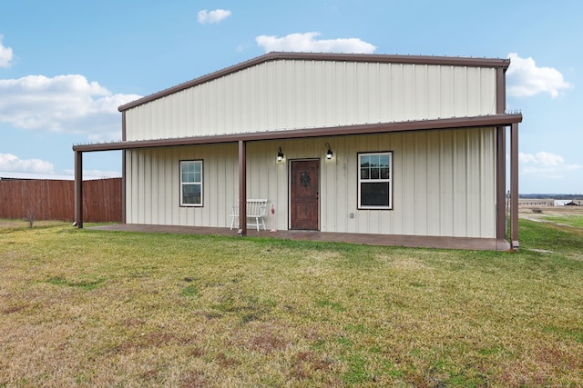 rear view of property featuring a porch and a lawn