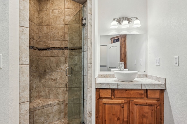 bathroom featuring vanity and a shower with door