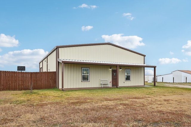 rear view of property with a yard