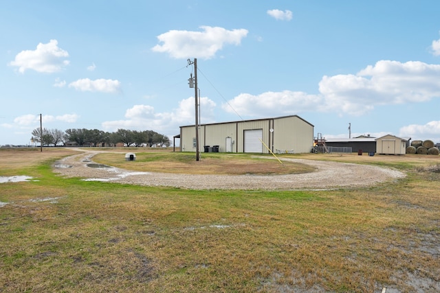 surrounding community with an outdoor structure and a yard