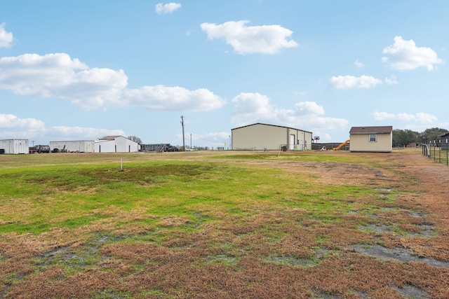 view of yard with a rural view and an outdoor structure