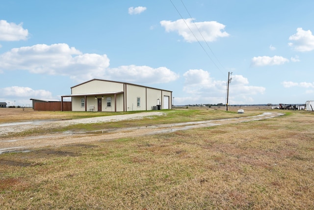 view of front facade with an outbuilding and a front lawn