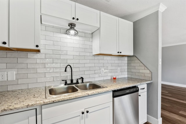 kitchen featuring dishwasher, crown molding, sink, tasteful backsplash, and white cabinetry