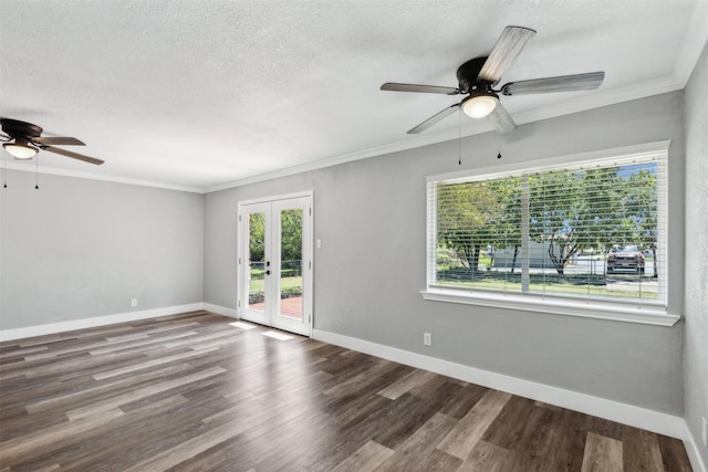 empty room with a textured ceiling, wood finished floors, baseboards, french doors, and ornamental molding