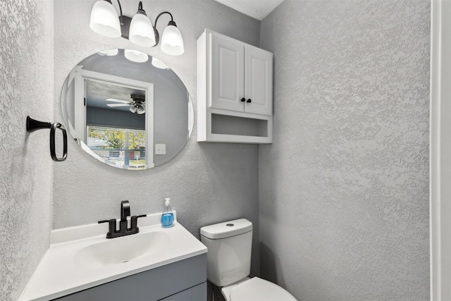 bathroom with vanity, toilet, and ceiling fan