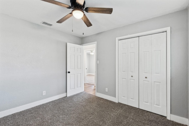 unfurnished bedroom featuring ceiling fan, a closet, and carpet floors