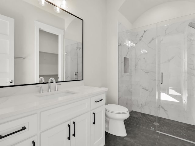 bathroom with vanity, an enclosed shower, and toilet