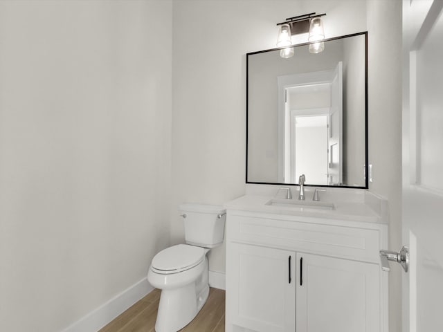 bathroom with vanity, hardwood / wood-style floors, and toilet