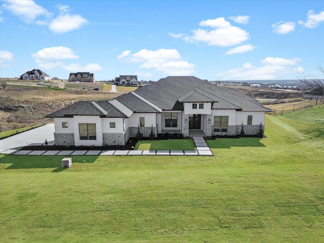 rear view of house featuring a lawn