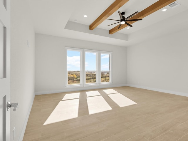 spare room with beamed ceiling, ceiling fan, and light hardwood / wood-style flooring