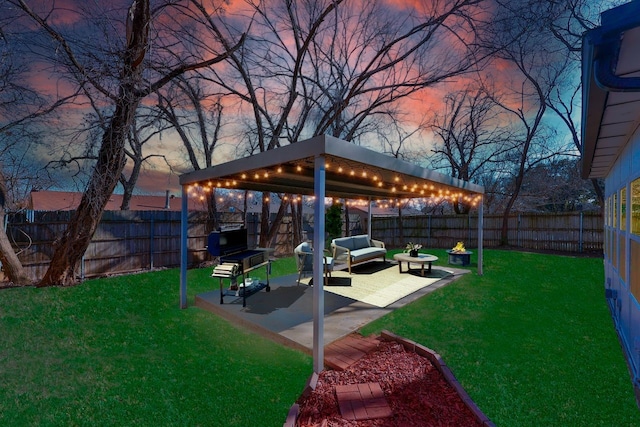 yard at dusk featuring a patio and an outdoor hangout area