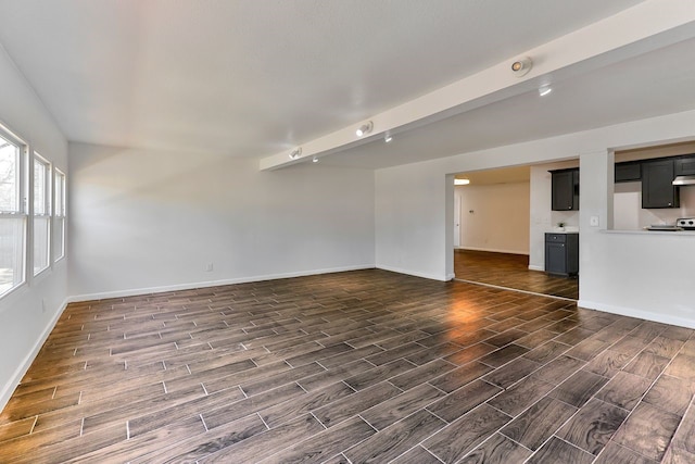 unfurnished living room with beamed ceiling