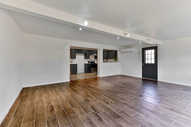 unfurnished living room with beamed ceiling and an AC wall unit