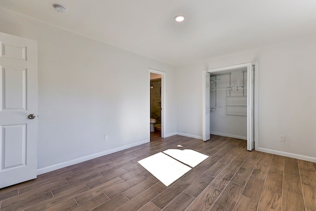 unfurnished bedroom featuring a closet and connected bathroom