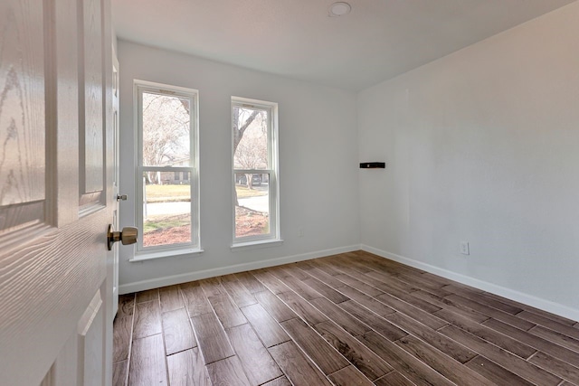 spare room featuring dark hardwood / wood-style flooring