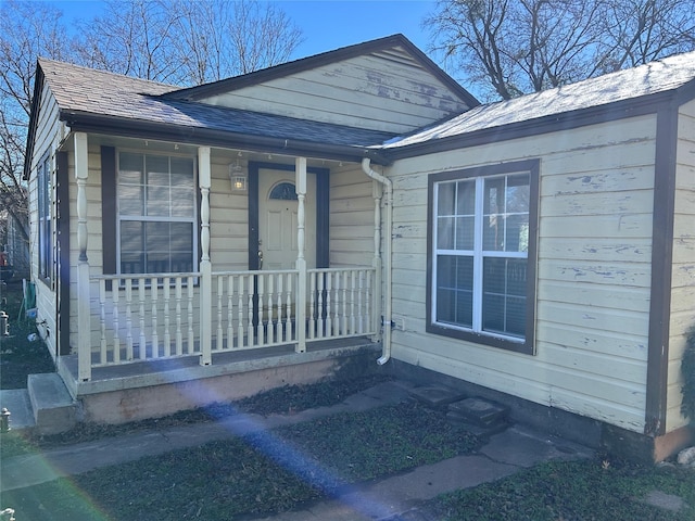 view of exterior entry with a porch