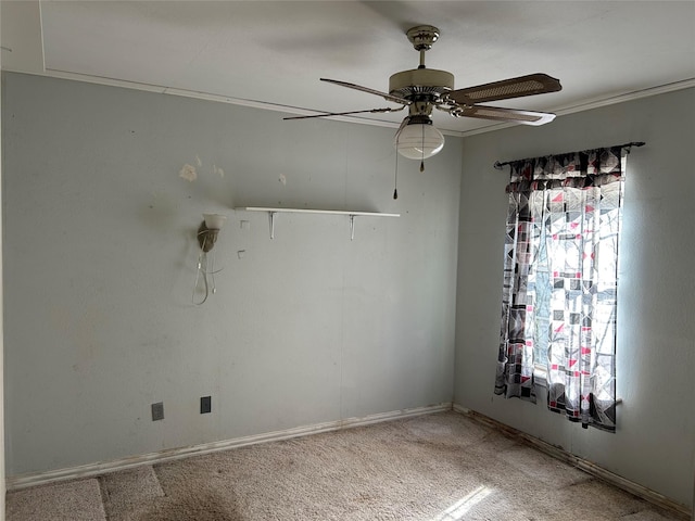 spare room featuring ceiling fan and carpet