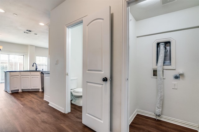 hall with dark wood-type flooring and sink