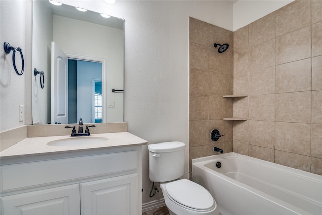 full bathroom with vanity, toilet, and tiled shower / bath