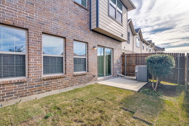 back of house featuring a yard, cooling unit, and a patio area