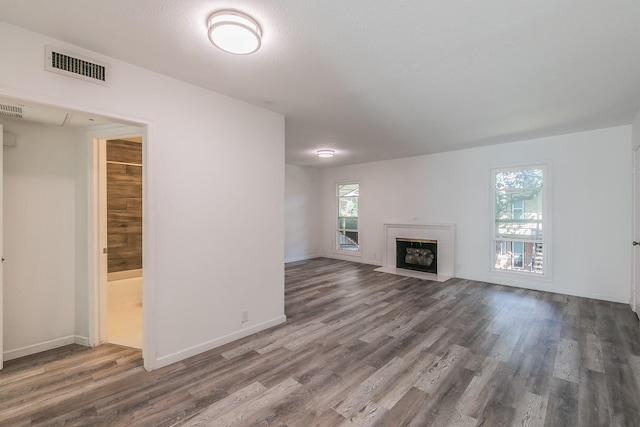 unfurnished living room featuring dark hardwood / wood-style floors