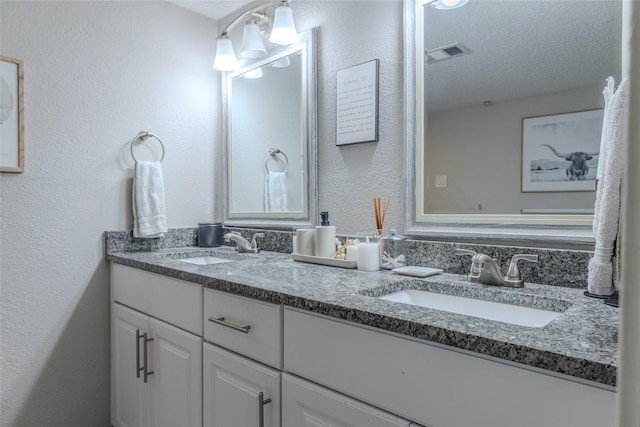 bathroom with vanity and a textured ceiling