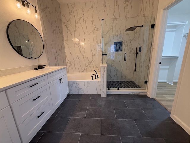 bathroom featuring tile patterned flooring, vanity, and separate shower and tub