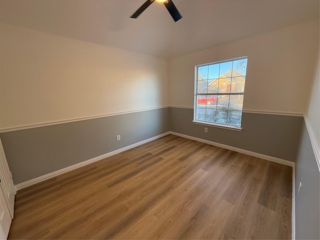 spare room with ceiling fan and light wood-type flooring