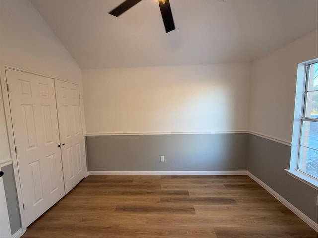 interior space with hardwood / wood-style flooring, ceiling fan, lofted ceiling, and a closet