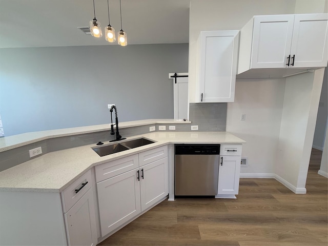 kitchen featuring stainless steel dishwasher, sink, white cabinetry, and hanging light fixtures