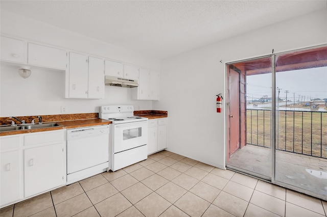 kitchen featuring a textured ceiling, white appliances, sink, white cabinets, and light tile patterned flooring