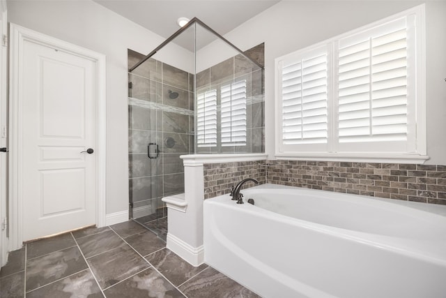 bathroom with tile patterned floors and shower with separate bathtub