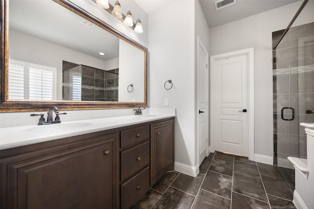 bathroom featuring vanity and a shower with shower door