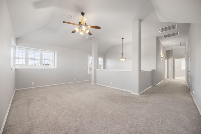 unfurnished room with ceiling fan, lofted ceiling, and light carpet