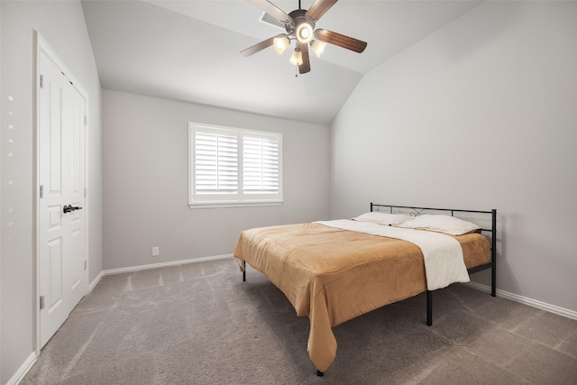 carpeted bedroom with vaulted ceiling and ceiling fan