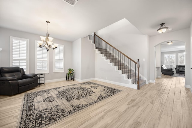 entryway with a notable chandelier and light hardwood / wood-style floors