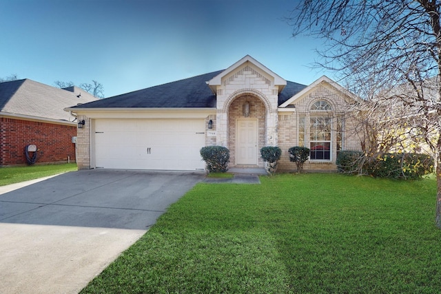 ranch-style home featuring a garage and a front yard