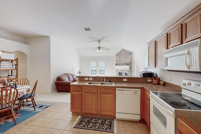 kitchen with ceiling fan, sink, lofted ceiling, white appliances, and light tile patterned floors