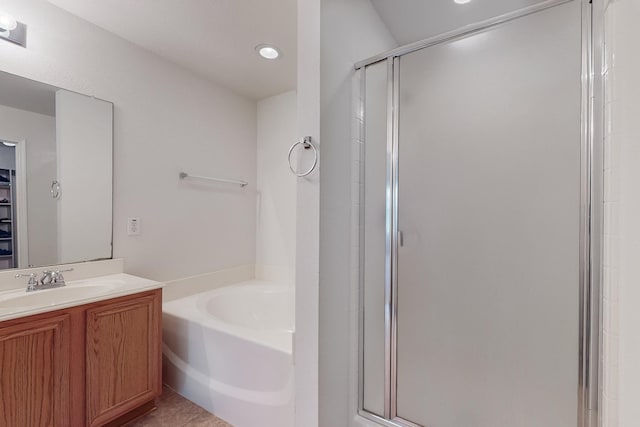 bathroom featuring tile patterned floors, vanity, and separate shower and tub