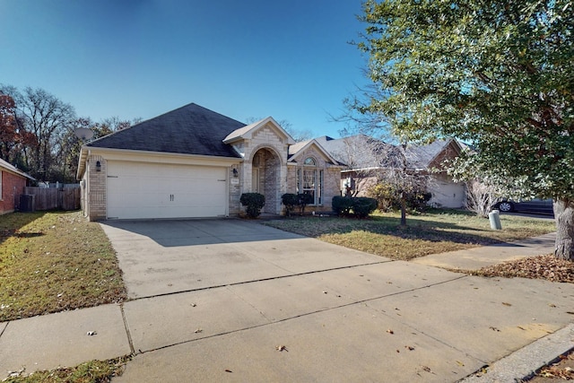 single story home with a front yard and a garage