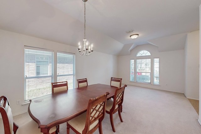 dining area with light carpet, lofted ceiling, and a notable chandelier