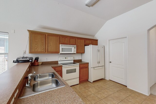 kitchen with light tile patterned floors, white appliances, lofted ceiling, and sink