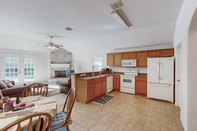 kitchen with french doors, sink, kitchen peninsula, white appliances, and light tile patterned floors