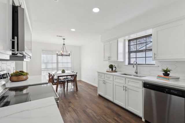 kitchen with pendant lighting, white cabinetry, sink, decorative backsplash, and stainless steel appliances