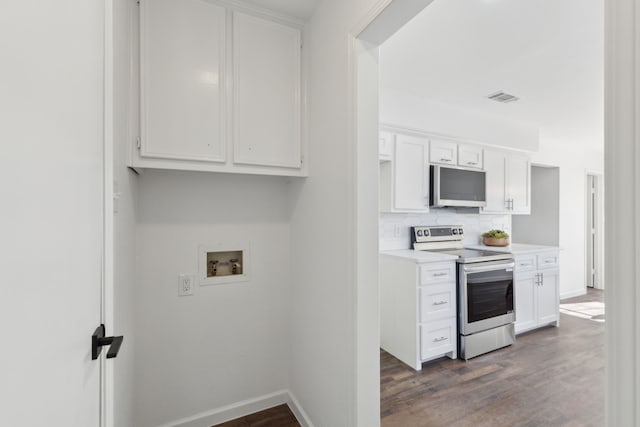 kitchen featuring white cabinetry, tasteful backsplash, dark hardwood / wood-style floors, and stainless steel electric range oven