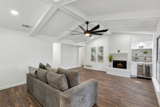 living room featuring dark hardwood / wood-style floors, a fireplace, lofted ceiling with beams, beverage cooler, and ceiling fan