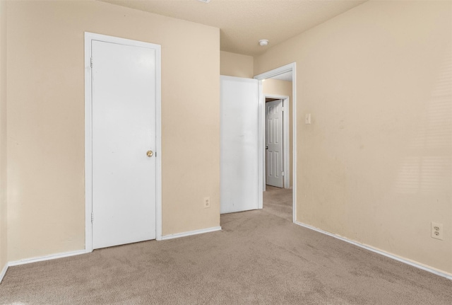 unfurnished bedroom featuring light colored carpet