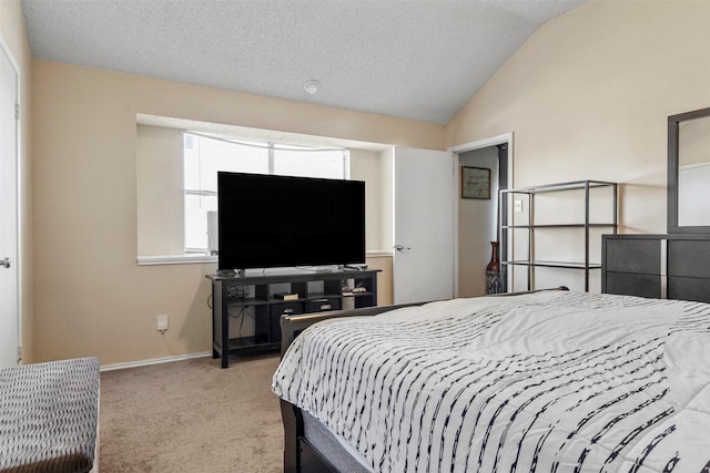 carpeted bedroom with a textured ceiling and vaulted ceiling