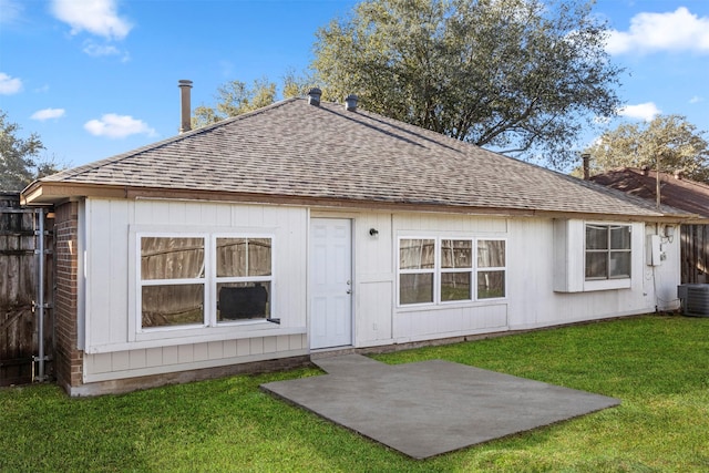 back of property featuring a patio area and a yard